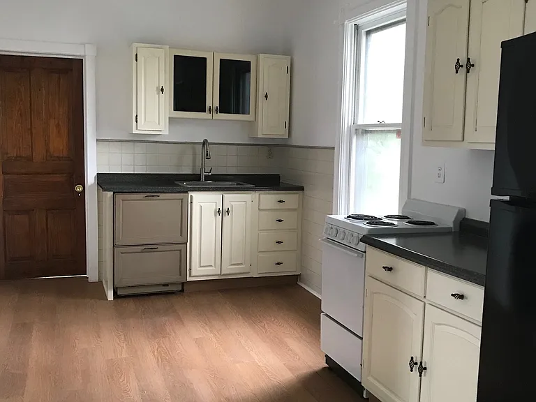Apartment has ceiling fans in kitchen and bedroom