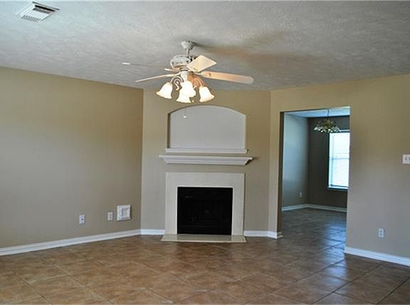 Large tiled family room with a gas fireplace.