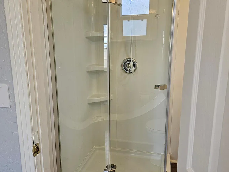Glass corner shower.