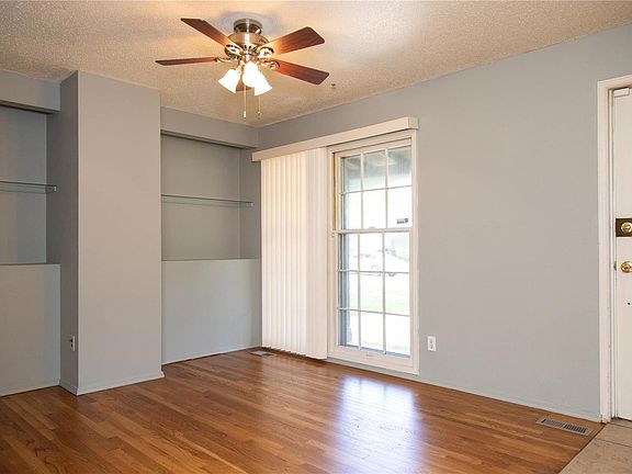 The is the living room. It has built in shelves and wood windows across the front of the home.