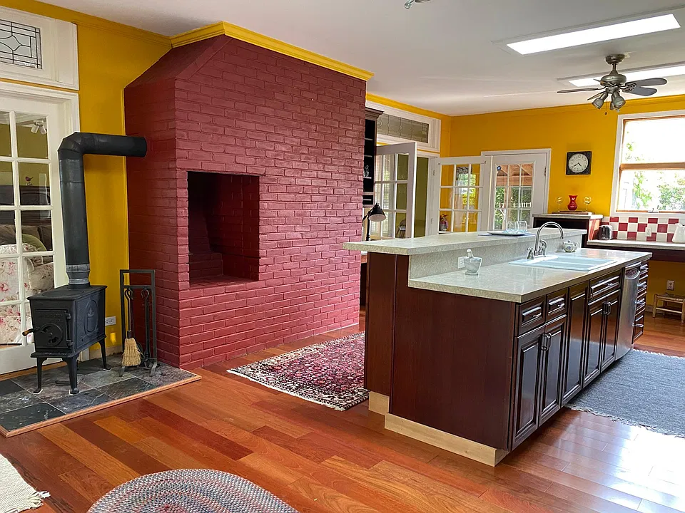 Very large chefs kitchen with hardwood floor, skylights and ceiling fans.
