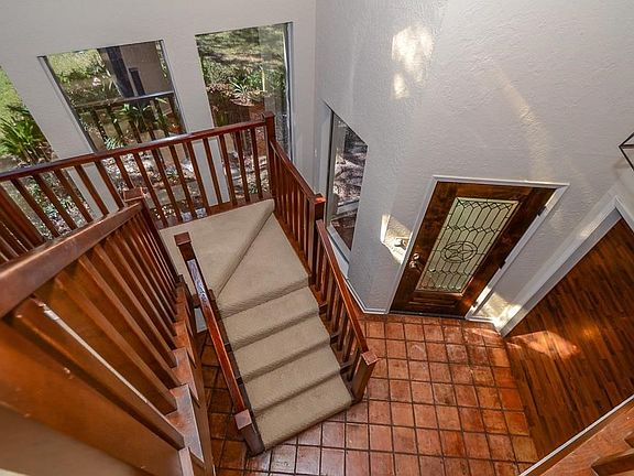 Your formal entry is spacious and well lit with updated lighting and floor to ceiling windows! This entry way leads you to the family room or up to the second floor or the home.