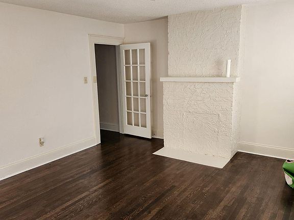 Spacious living room. Hardwood floors throughout house. Architectural details.