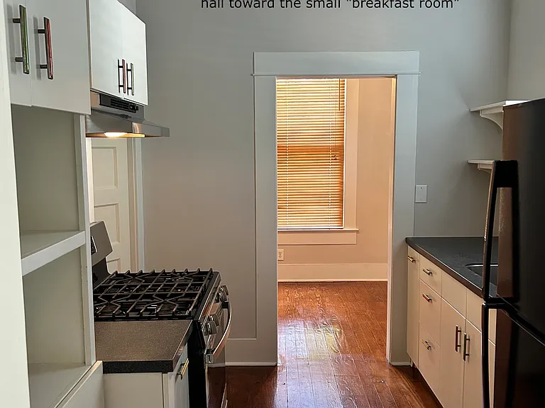 Entrance to galley kitchen with view into the "breakfast room". Some have used this small 7x8 as an office and some have found a small dining table and the artist put her antique bed in it so the "bedroom" was her studio.