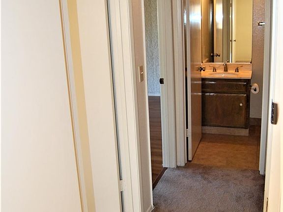 From Master Bedroom, down hallway toward past Bedroom 2, Living Room, toward main Bathroom