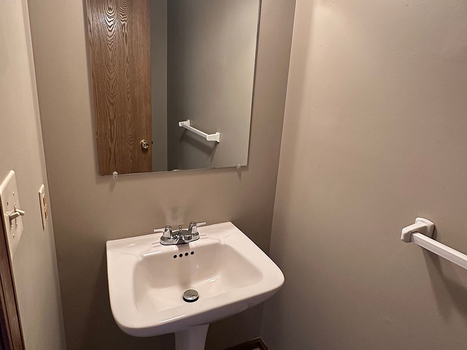 The half bath on the first floor boasts a pedestal sink.
