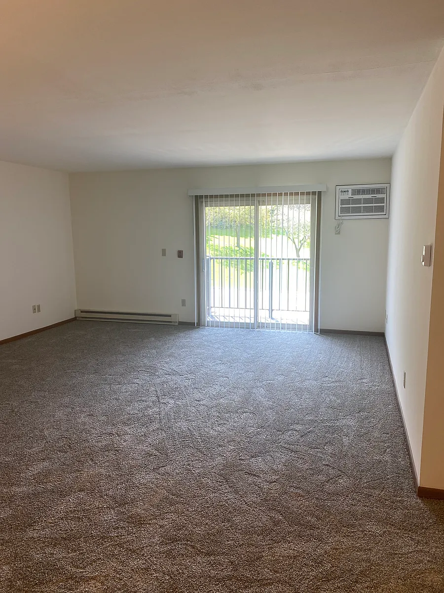 Patio with balcony facing back of building. - Arrowhead Heights