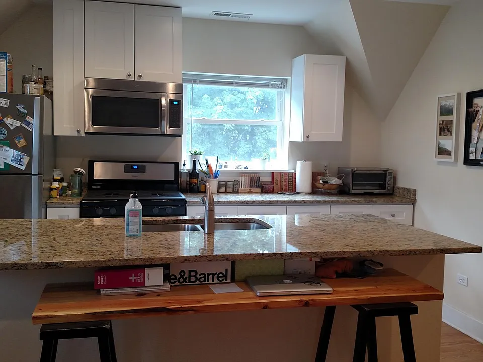 Kitchen has a sit at granite island
