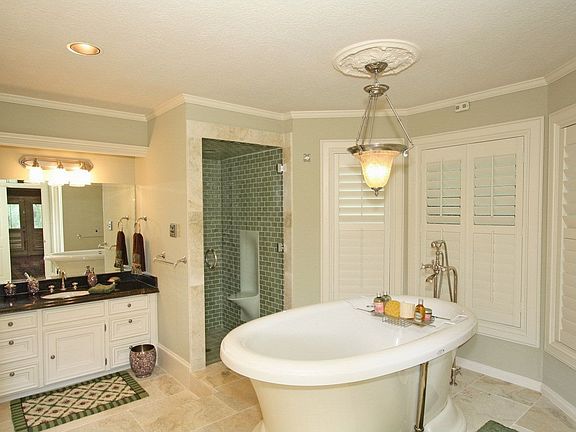 Spa retreat master bath- limestone flooring, cracked porcelain glass tile