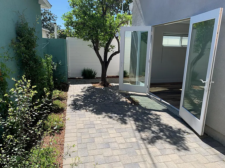 Sunny private patio with flowers and trees