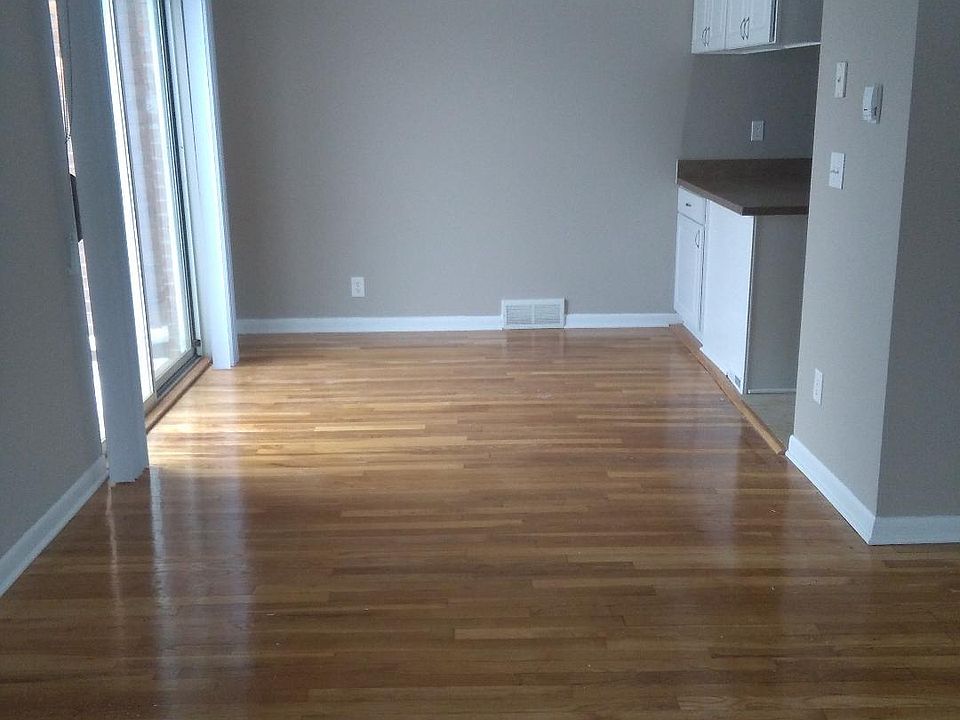 living room into dining room, patio door looking onto Marguerite Ave. and Groesbeck neighborhood