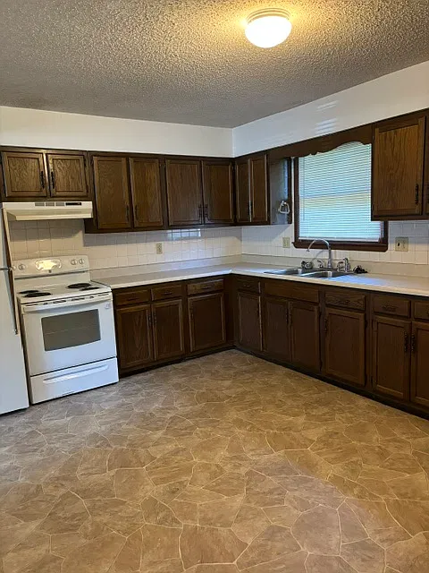 Kitchen with stove and refrigerator.