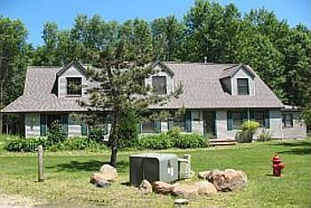 This beautiful home is sits on a 1.05 Acre wooded lot surrounded by other large wooded parcels and distinquished homes. there are 28 buildable sites in this subdivision. A small creek runs down the center of the subdivision and out into the lake, it runs right along the roadside in front of this home. Cross the sharming bridge over the creek and drive into your property.