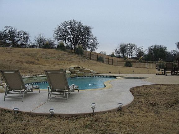 Hilled and treed yard with Pool & spa