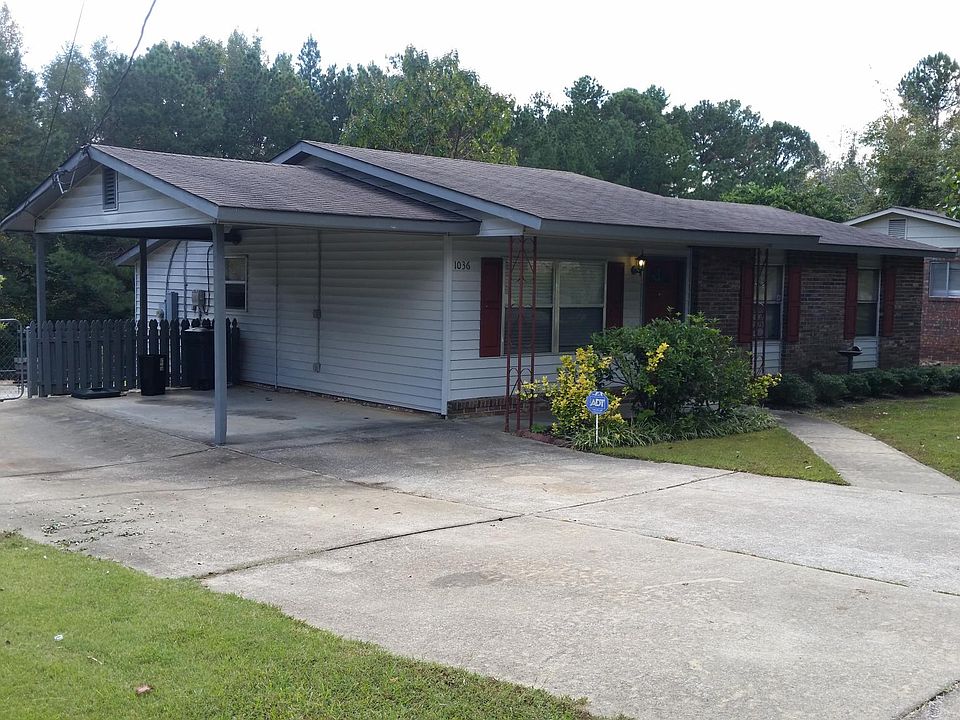 Carport and wide concrete driveway.