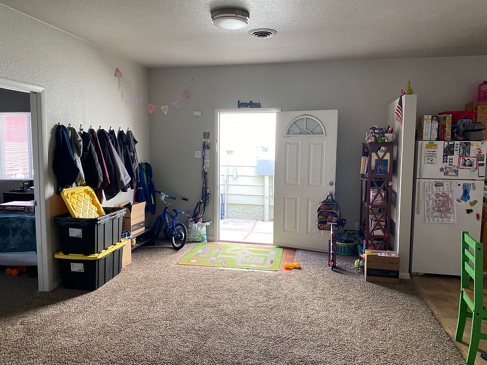 View of living area and exterior entrance. Also, view of kitchen and bedroom 2 entrance.