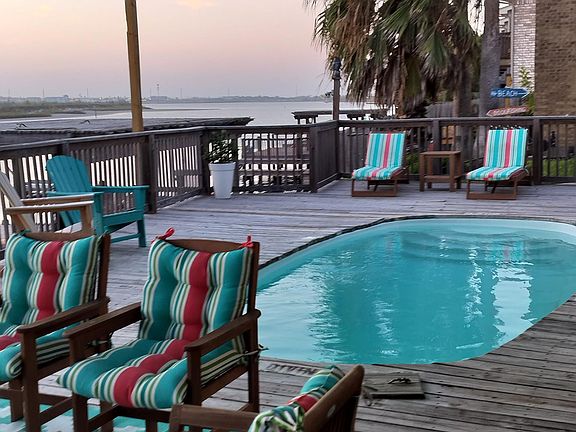 Sitting area at the pool overlooking canal on Lake Padre.