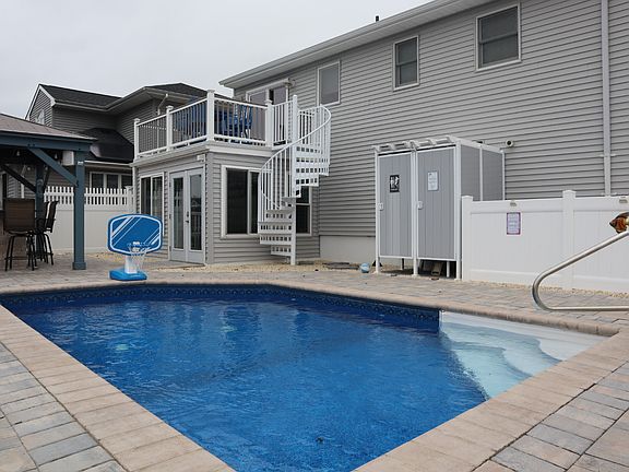 Pool with outdoor shower and bathroom