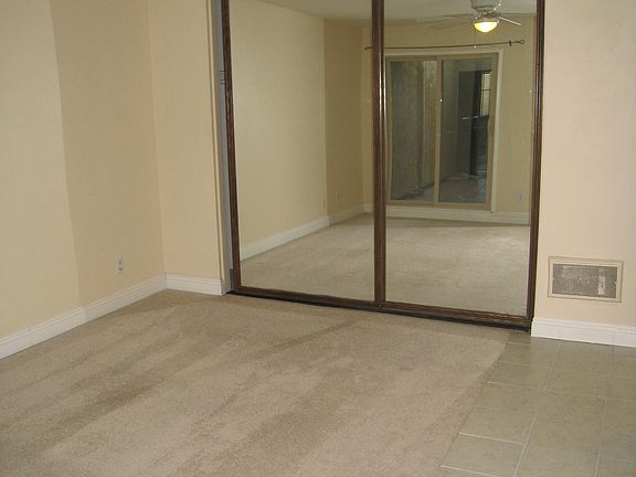 spacious bedroom with large mirror closet