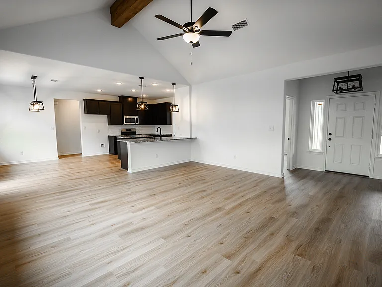Open Concept Family Room looking into Dining, Kitchen and Foyer