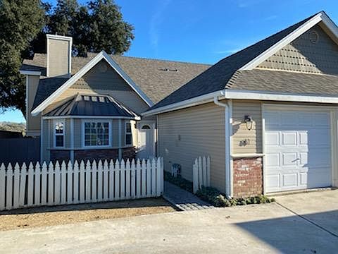 Small fenced lawn in front, one car garage