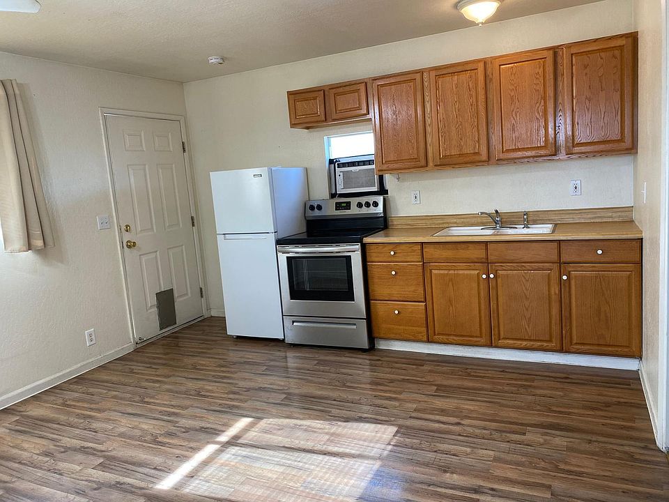 Kitchen equipped with refrigerator and stove with oven