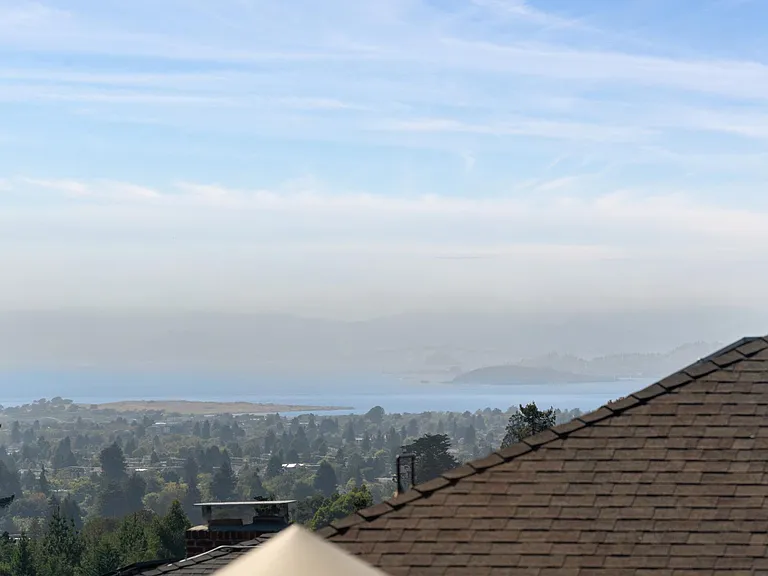 The view from the primary bedroom. There's a bridge there, through the fog.