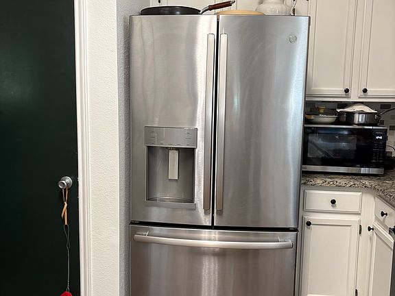 Kitchen has pots and pans, windows