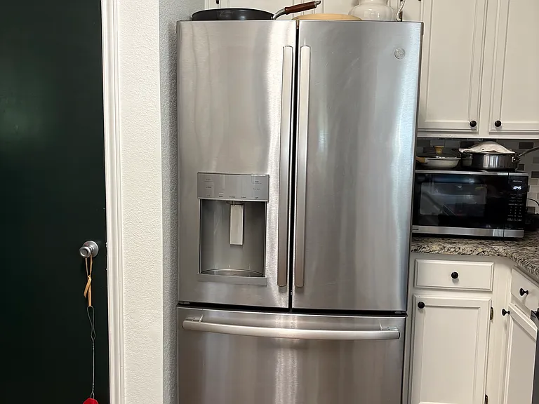 Kitchen has pots and pans, windows
Great French door Frigidaire refrigerator. Very roomy!