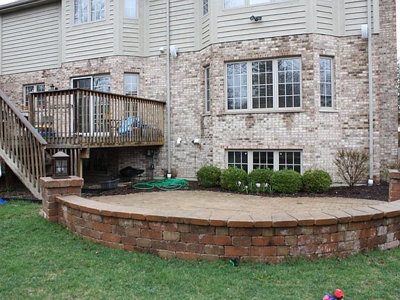 Fully fenced yard with deck and paver brick patio