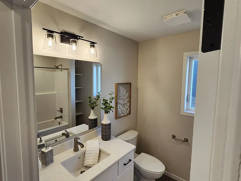 Full upstairs bath. (Pictures are of another unit with similar finishes and features.)