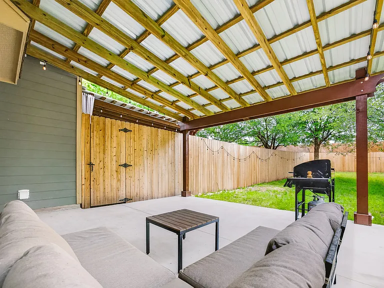 Large, covered outdoor patio; Grill, lighting, and patio furniture included