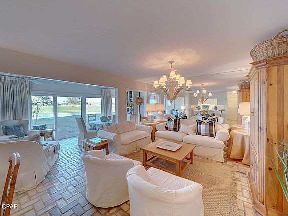 View of Living Room & Sun Room w/high impact glass & sliding doors across the back