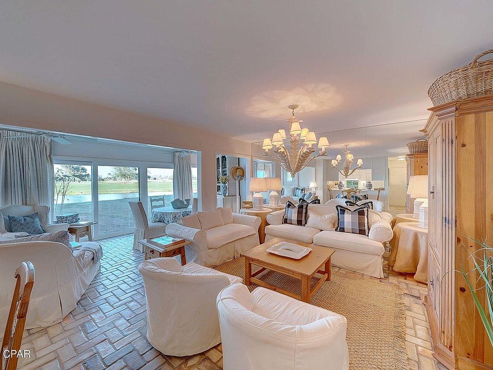 View of Living Room & Sun Room w/high impact glass & sliding doors across the back
