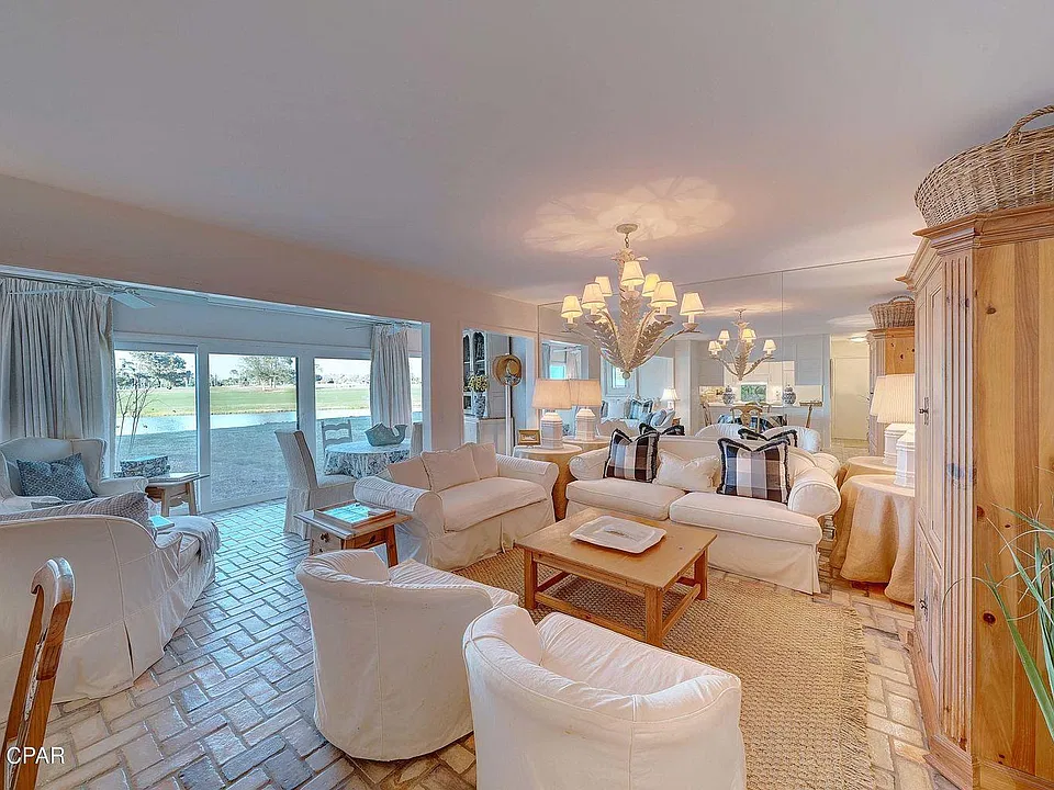 View of Living Room & Sun Room w/high impact glass & sliding doors across the back