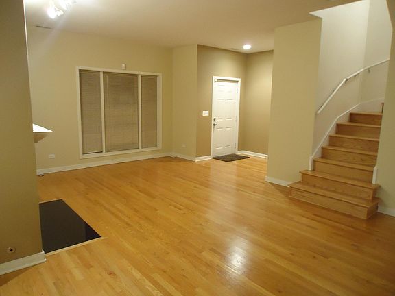 Spacious living room with large windows.
