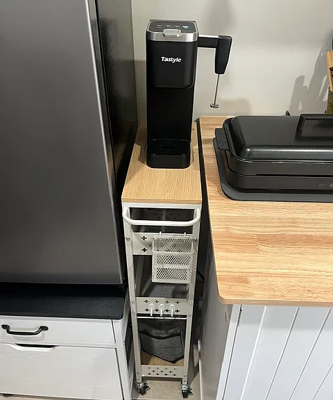 Coffee maker with frother wand, cart holds toaster as well.
