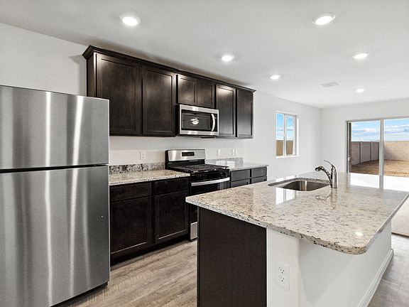 Impressive kitchen with large island and granite countertops.