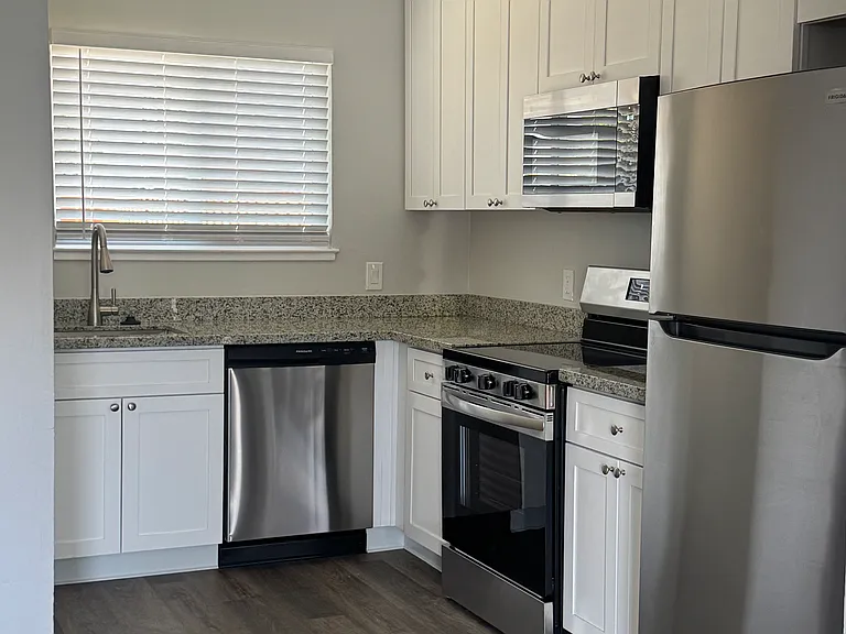Kitchen includes dishwasher, garbage disposal, stove, microwave and full-size refrigerator.