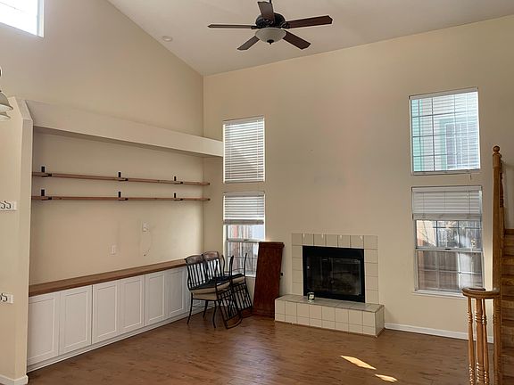 Large great room with fireplace and built in cabinets and shelving. High windows and south exposure make this a sunny room.