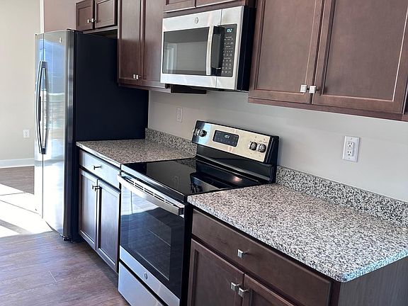 Classic gourmet kitchen includes Whirlpool appliances and granite countertops.