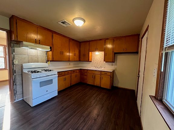 kitchen with backdoor to back yard leading to garage