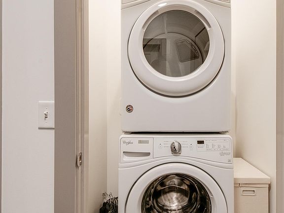 Washer/dryer included with additional laundry room storage.