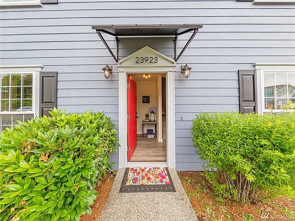 The updates start here with new lights, awning, shutters and a fresh front door!