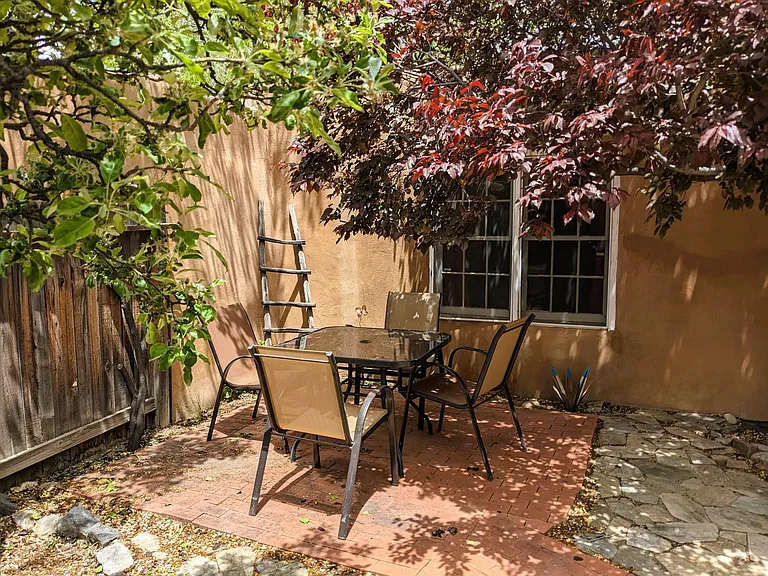 Private, quiet courtyard patio dining, shaded by an apple tree, a plum tree, and a cottonwood.