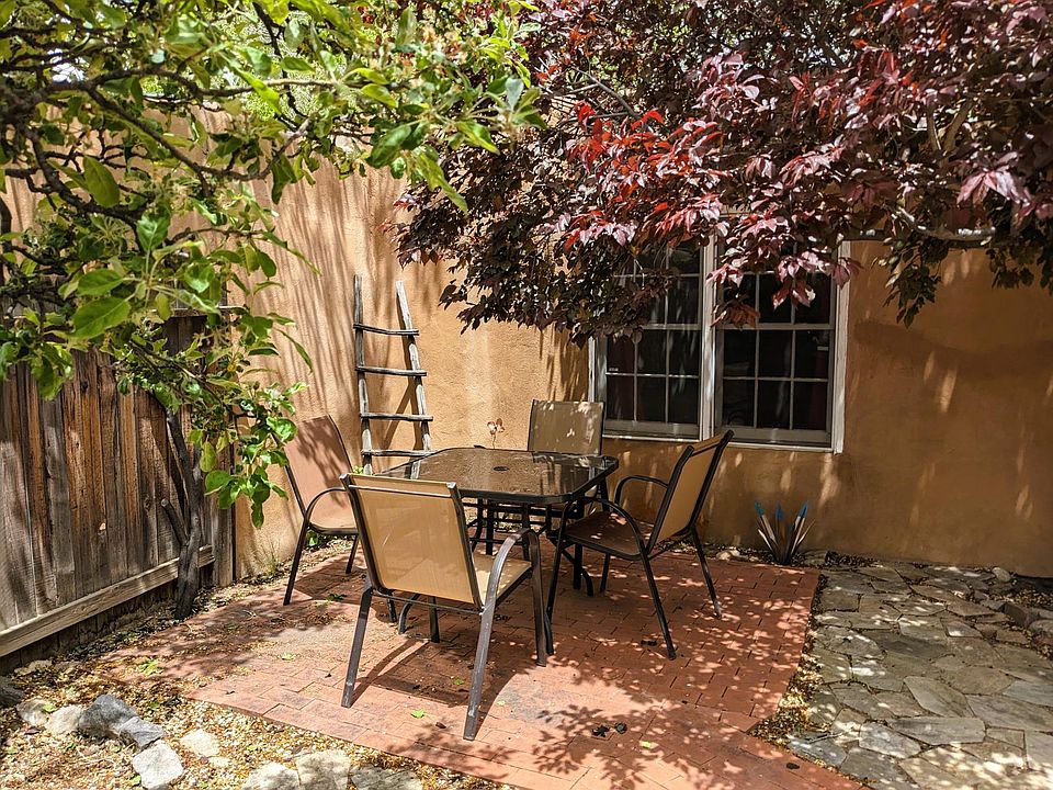 Private, quiet courtyard patio dining, shaded by an apple tree, a plum tree, and a cottonwood.