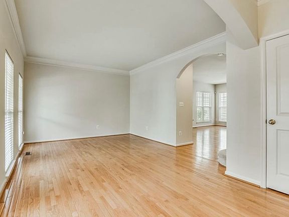 Front room area and entryway. Tall cathedral ceilings with lots of natural light.