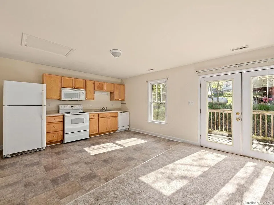 Other side of main living space showing kitchen area