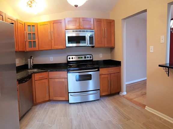 Kitchen is open and equipped with full sized appliances