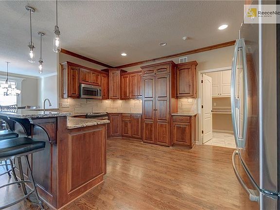 Spacious kitchen opens to living, dining, laundry room.